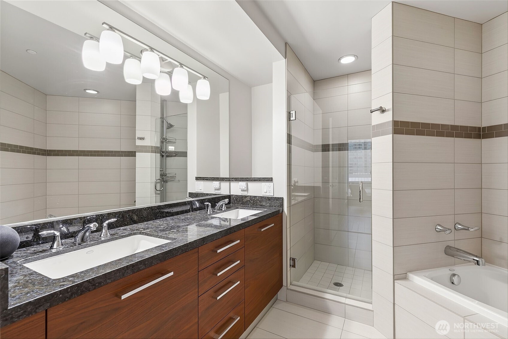 1920 4th Avenue, Unit 509 Seattle, WA 98101 - Photo 17 of 33 a bathroom with a sink double vanity and a bathtub