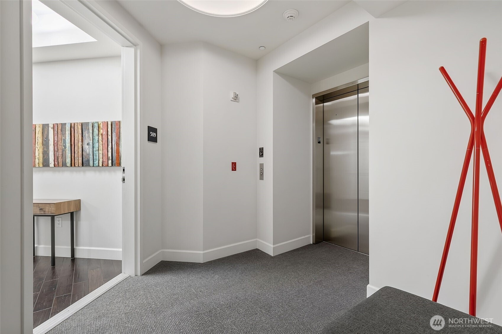 1920 4th Avenue, Unit 509 Seattle, WA 98101 - Photo 2 of 33 a view of a hallway with hallway and wooden floor