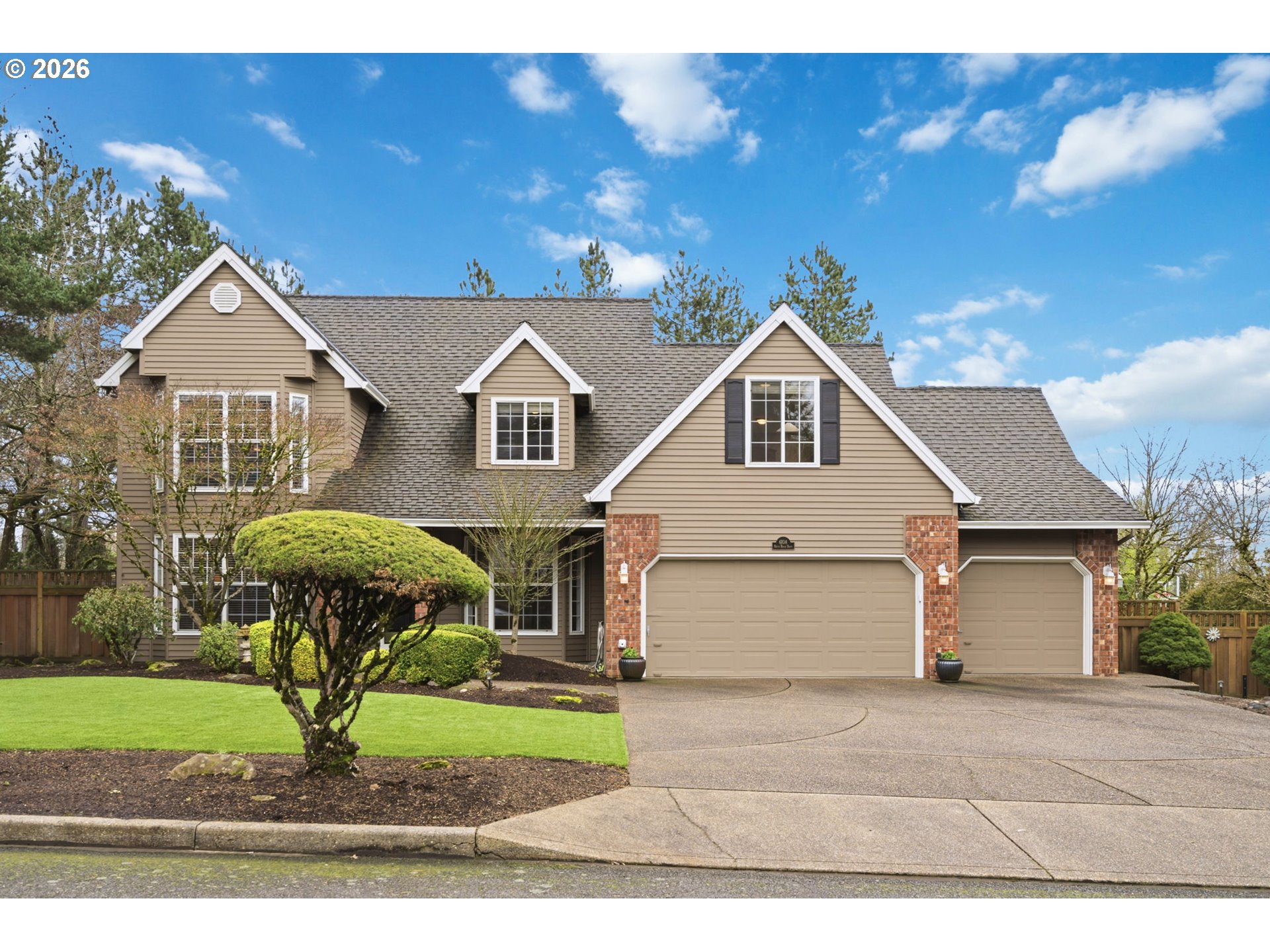 6108 Southwest Kruse Ridge Drive Portland, OR 97219 - Photo 1 of 42 a front view of a house with garden