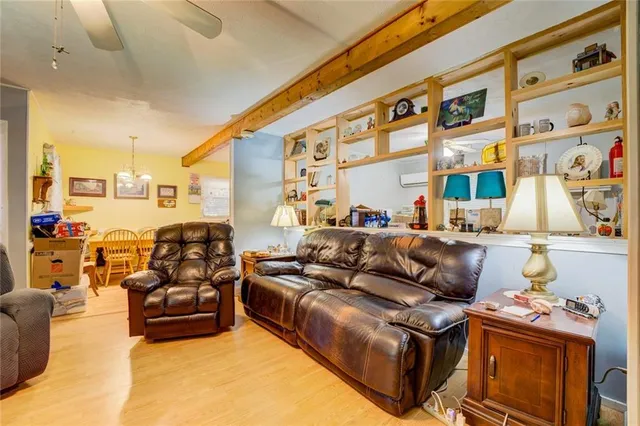 a living room with furniture fireplace and a window