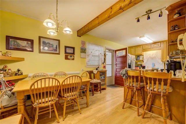 a view of a dining room with furniture and chandelier