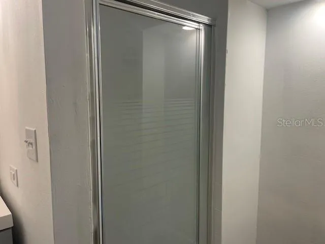 a bathroom with a glass shower door