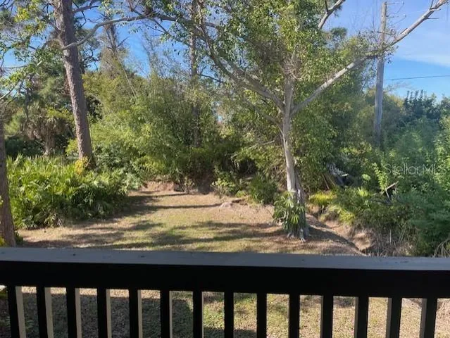 a view of a hallway with wooden floor and closet