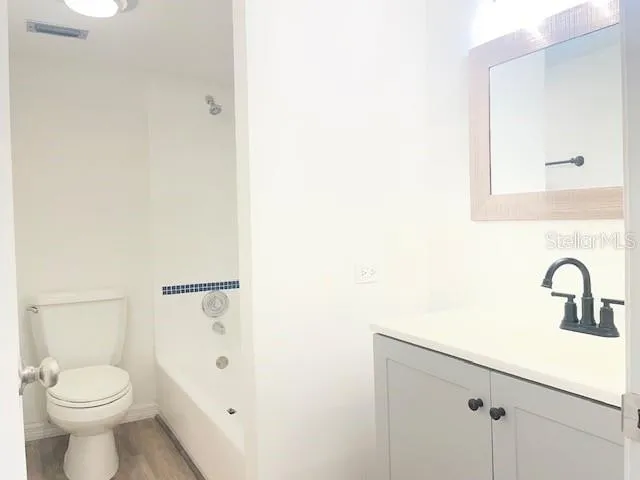 a view of a swimming pool with a table and chairs under an umbrella