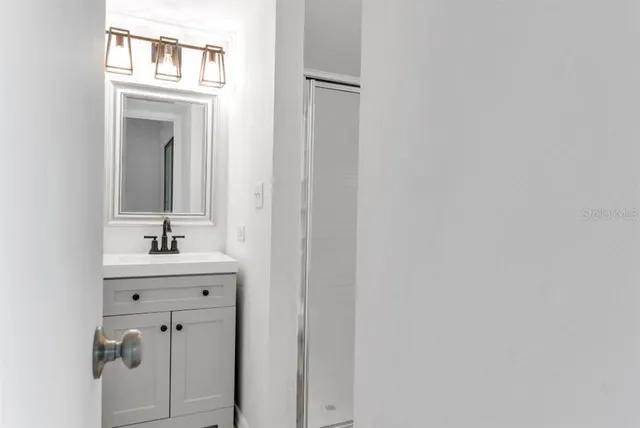 a bathroom with a sink and a mirror