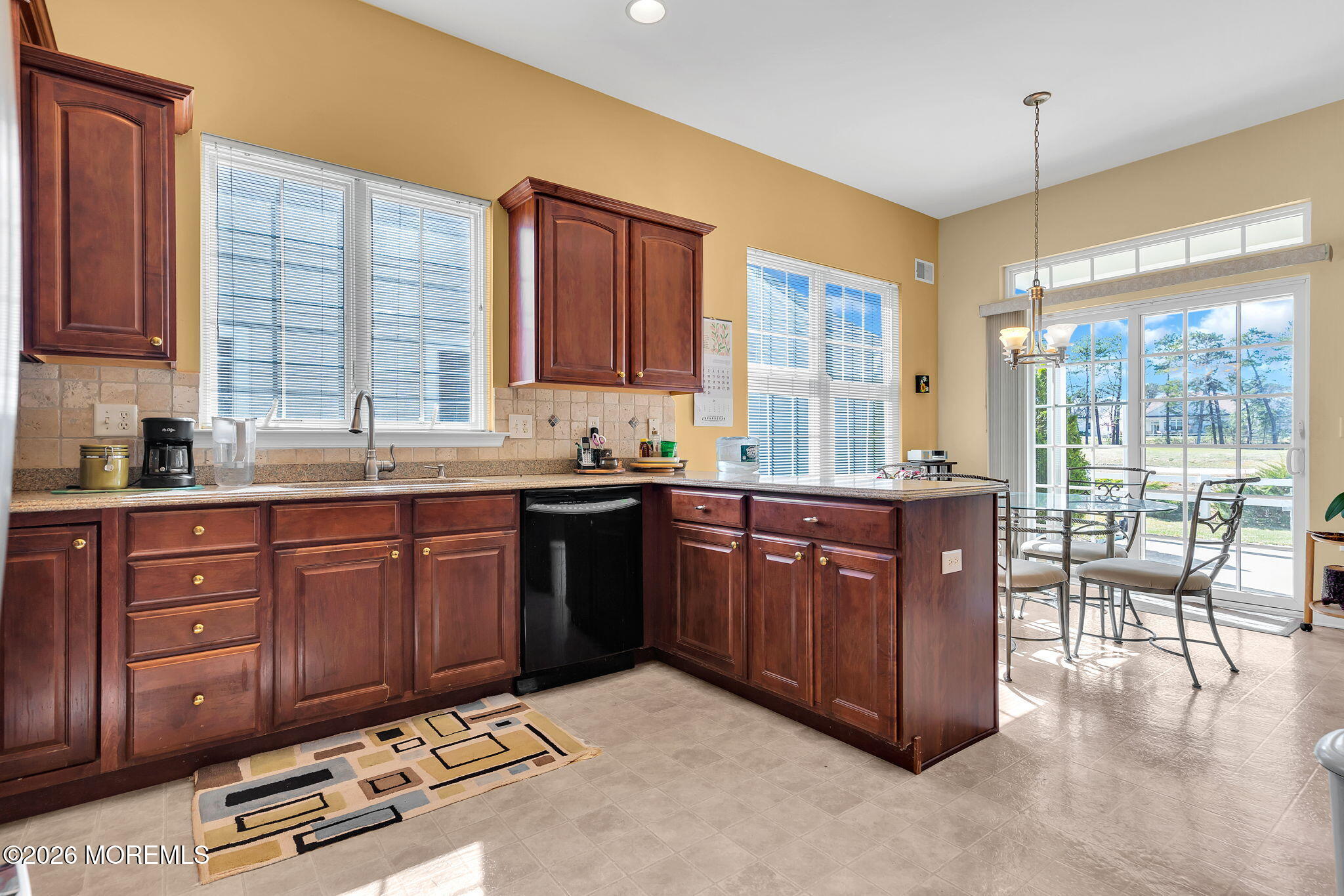 35 Spring Lake Boulevard Waretown, NJ 08758 - Photo 12 of 51 a large kitchen with kitchen island granite countertop wooden cabinets a granite counter and a large window