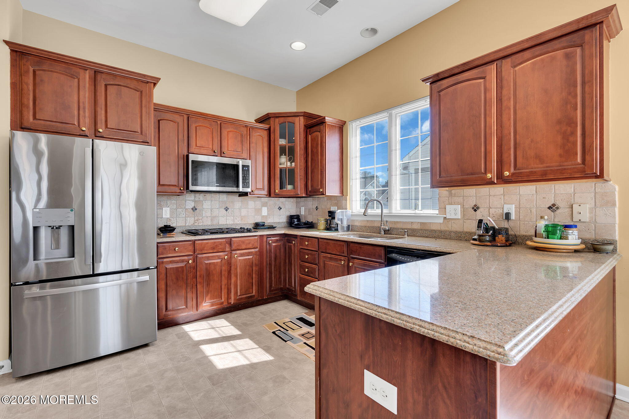 35 Spring Lake Boulevard Waretown, NJ 08758 - Photo 14 of 51 a kitchen with stainless steel appliances granite countertop a refrigerator a sink dishwasher a stove with wooden cabinets and a granite counter top