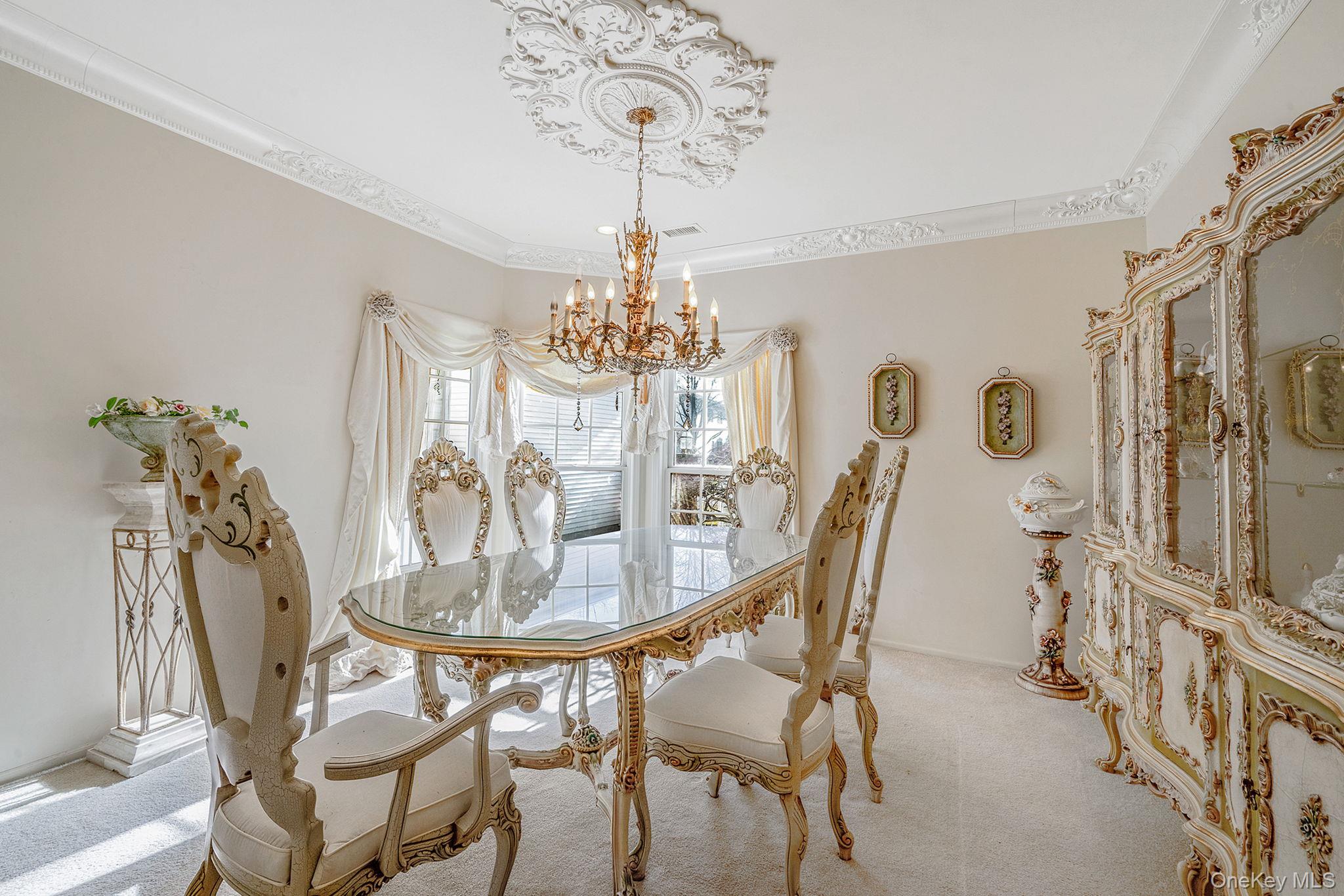 148 Country Club Drive Commack, NY 11725 - Photo 11 of 50 a dining room with furniture a chandelier and wooden floor