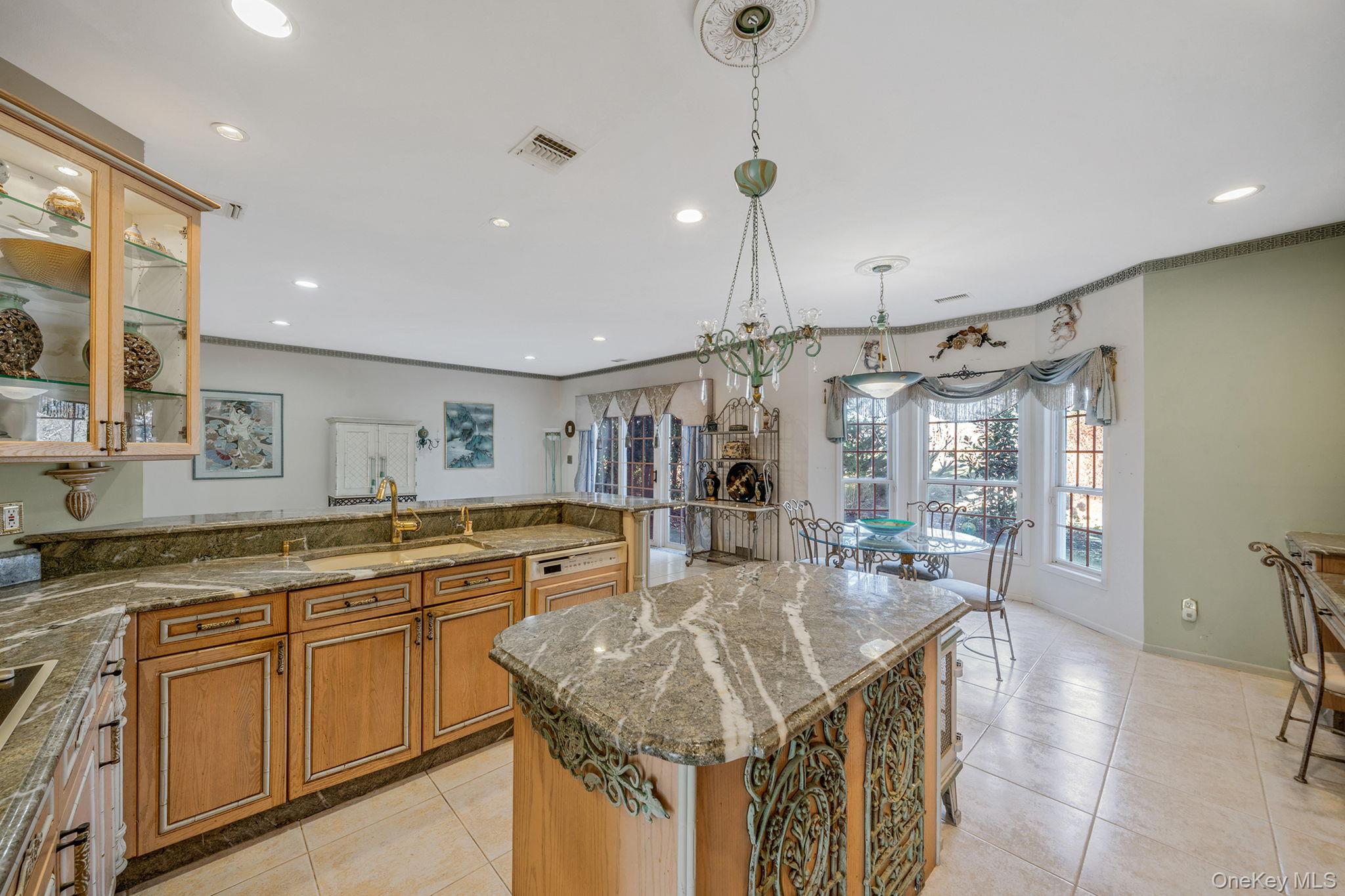 148 Country Club Drive Commack, NY 11725 - Photo 12 of 50 a kitchen with center island center island stainless steel appliances and furniture
