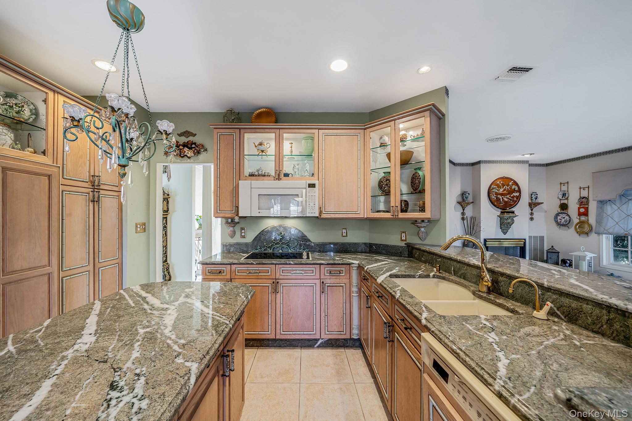 148 Country Club Drive Commack, NY 11725 - Photo 13 of 50 a kitchen with granite countertop a sink stove and refrigerator