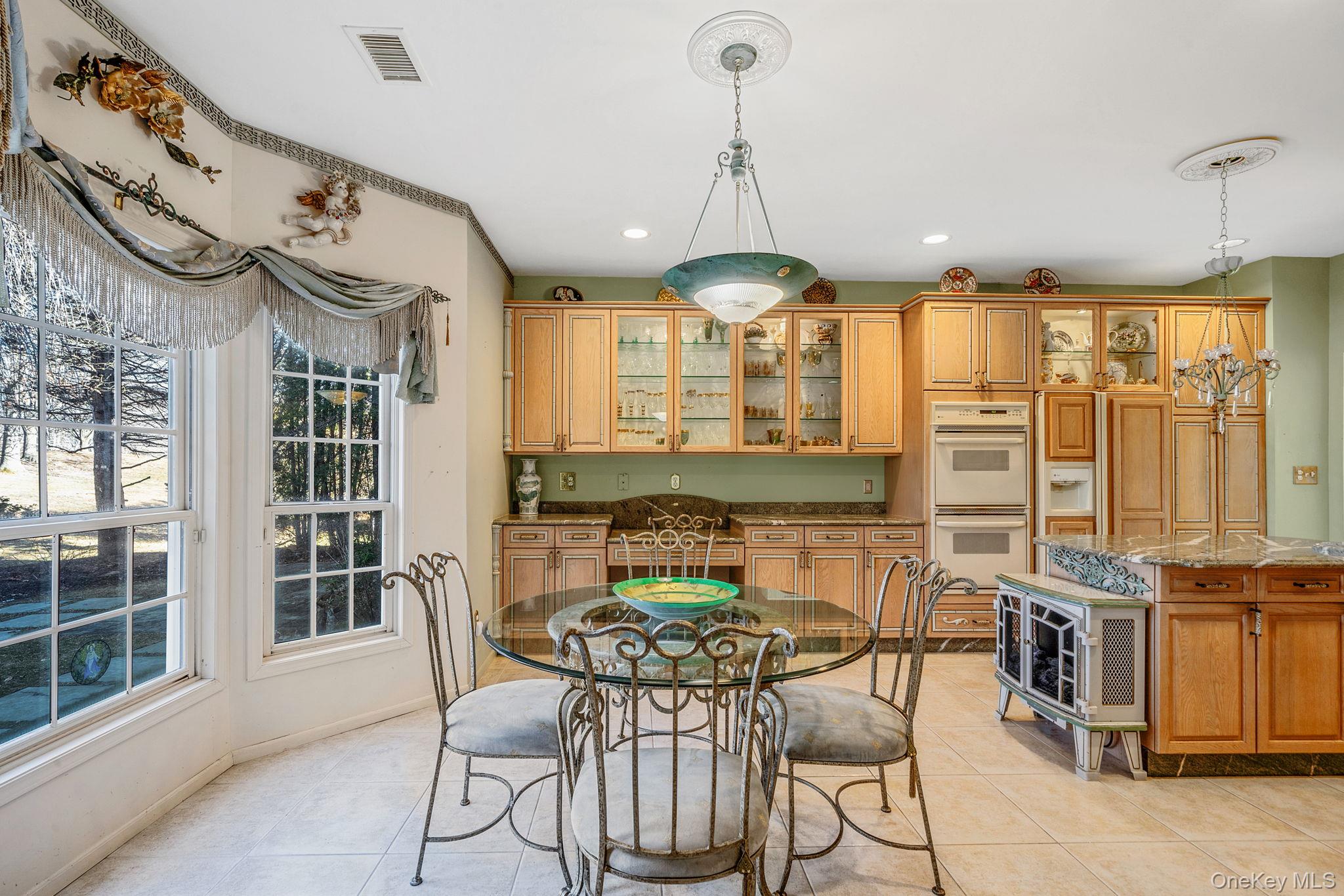 148 Country Club Drive Commack, NY 11725 - Photo 16 of 50 a view of a dining room with furniture and chandelier