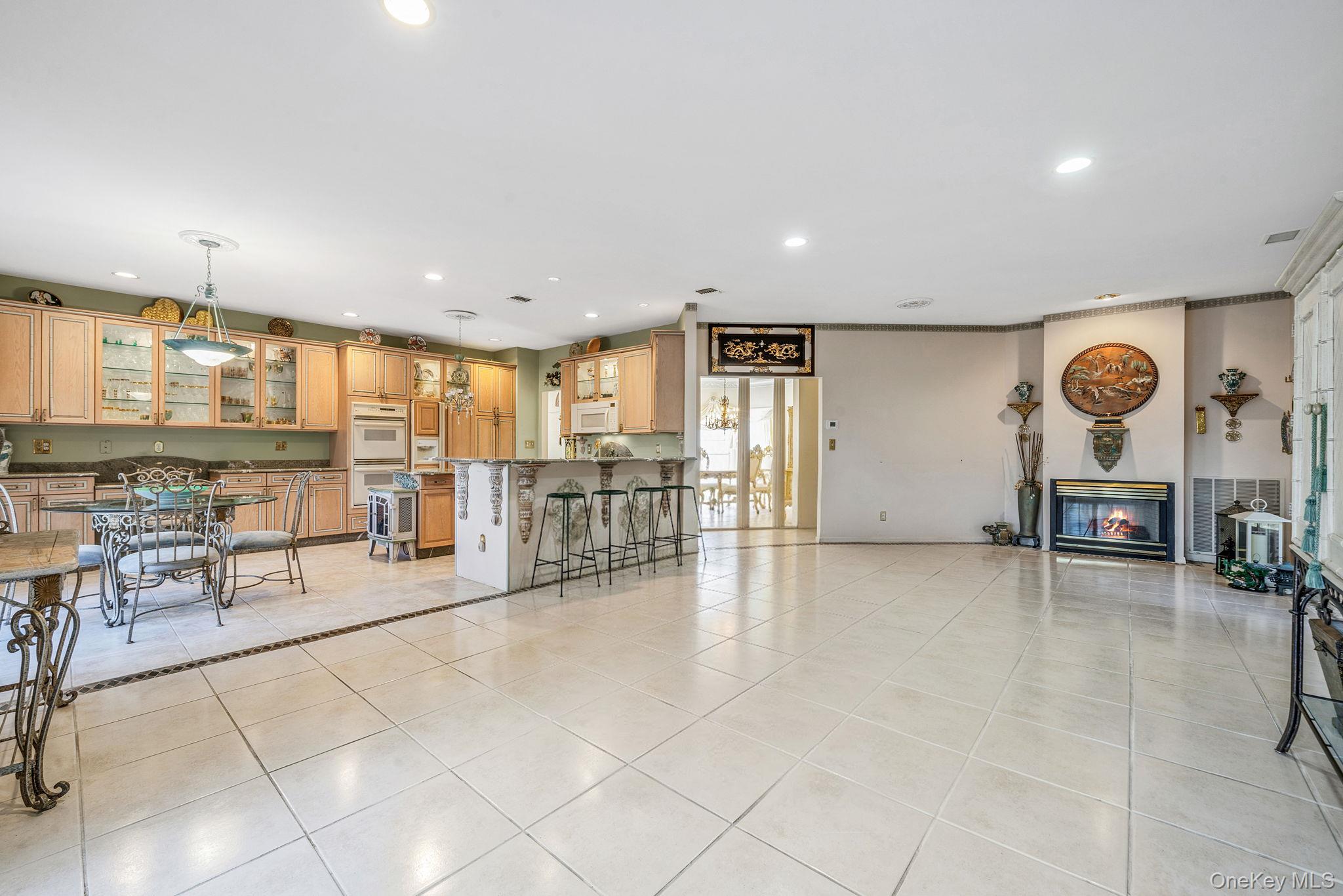 148 Country Club Drive Commack, NY 11725 - Photo 17 of 50 a view of a kitchen with furniture and floor to ceiling window