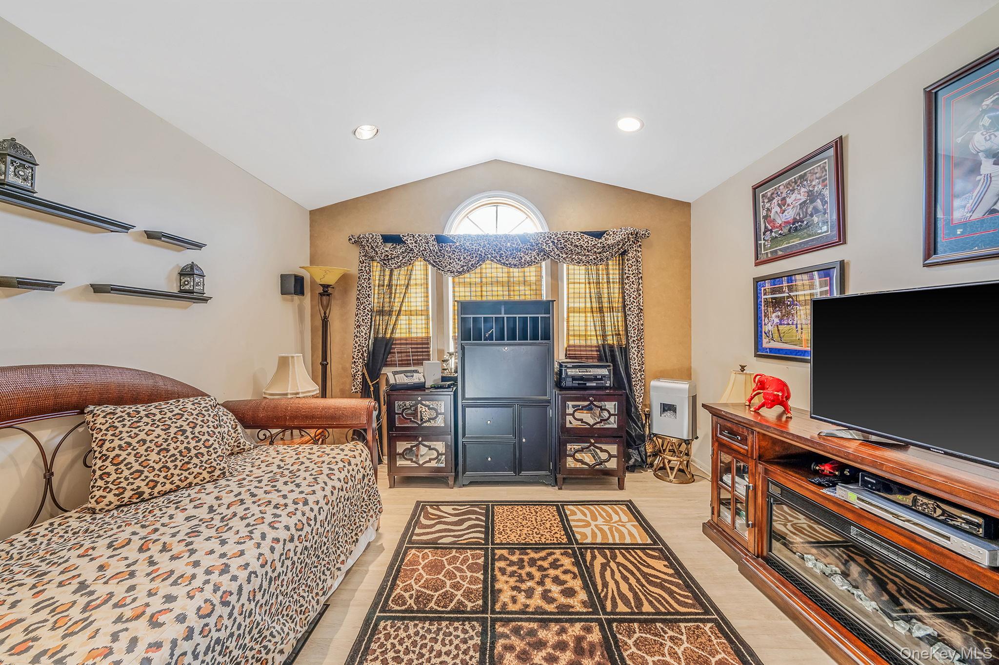 148 Country Club Drive Commack, NY 11725 - Photo 20 of 50 a bedroom with furniture and a flat screen tv