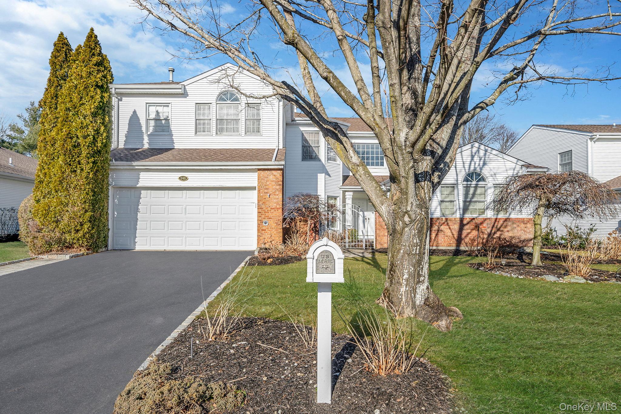 148 Country Club Drive Commack, NY 11725 - Photo 2 of 50 a front view of a house with garden