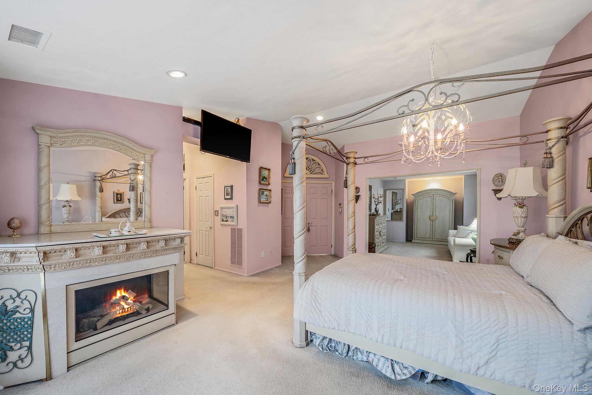 148 Country Club Drive Commack, NY 11725 - Photo 23 of 50 a bedroom with a bed and a fireplace