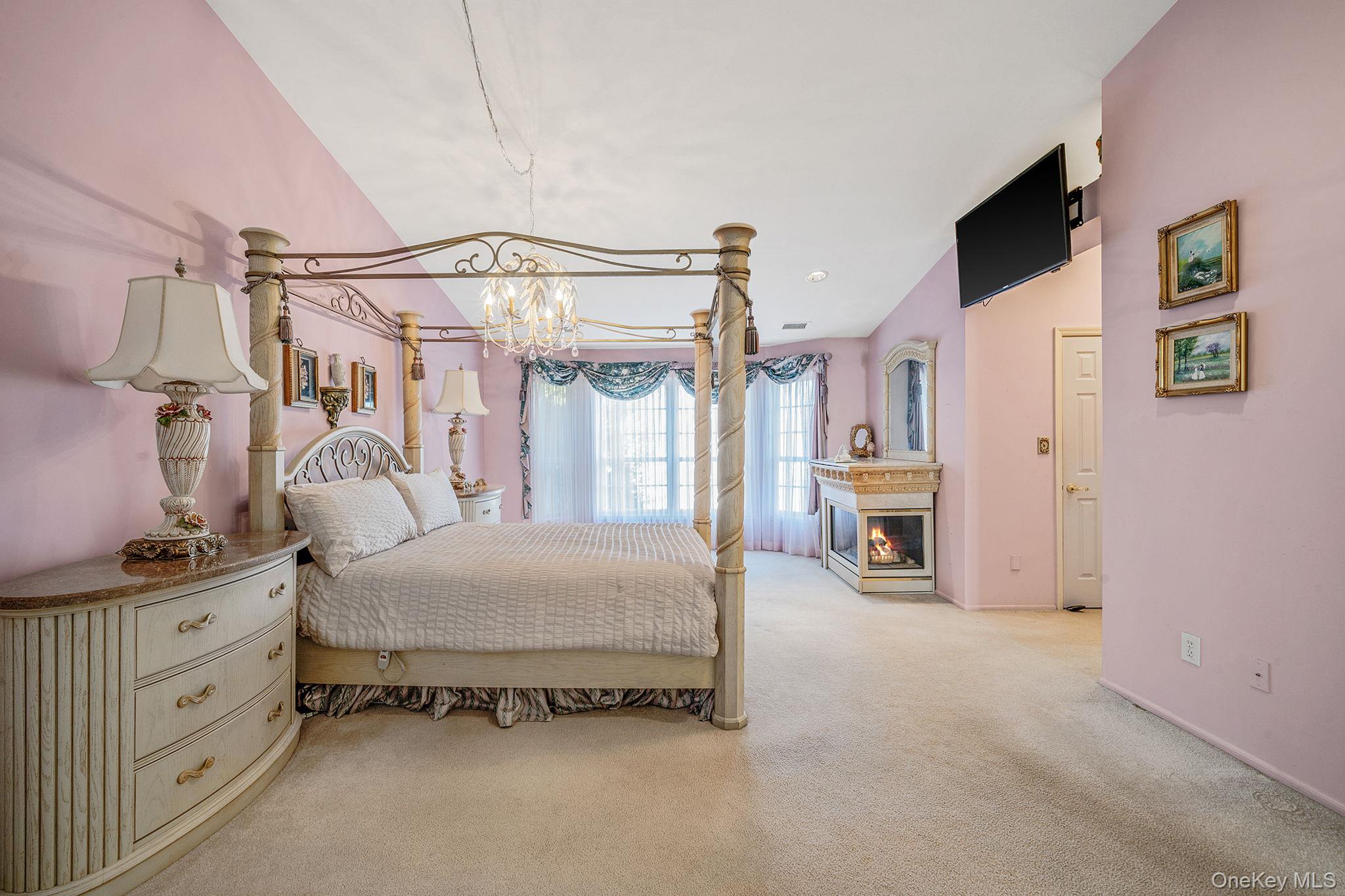 148 Country Club Drive Commack, NY 11725 - Photo 24 of 50 a spacious bedroom with a bed and a walk in closet