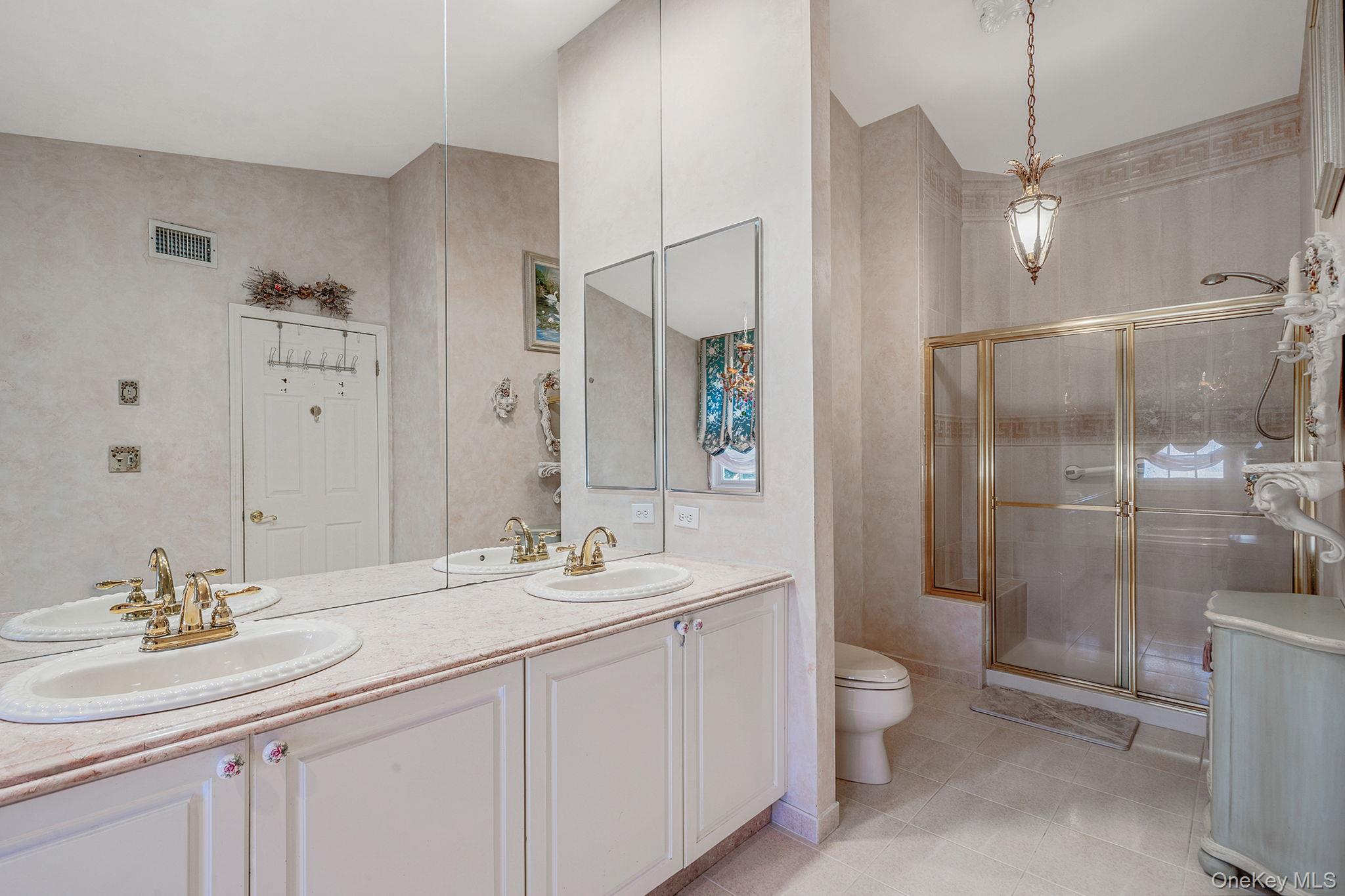 148 Country Club Drive Commack, NY 11725 - Photo 27 of 50 a bathroom with a double vanity sink mirror and toilet