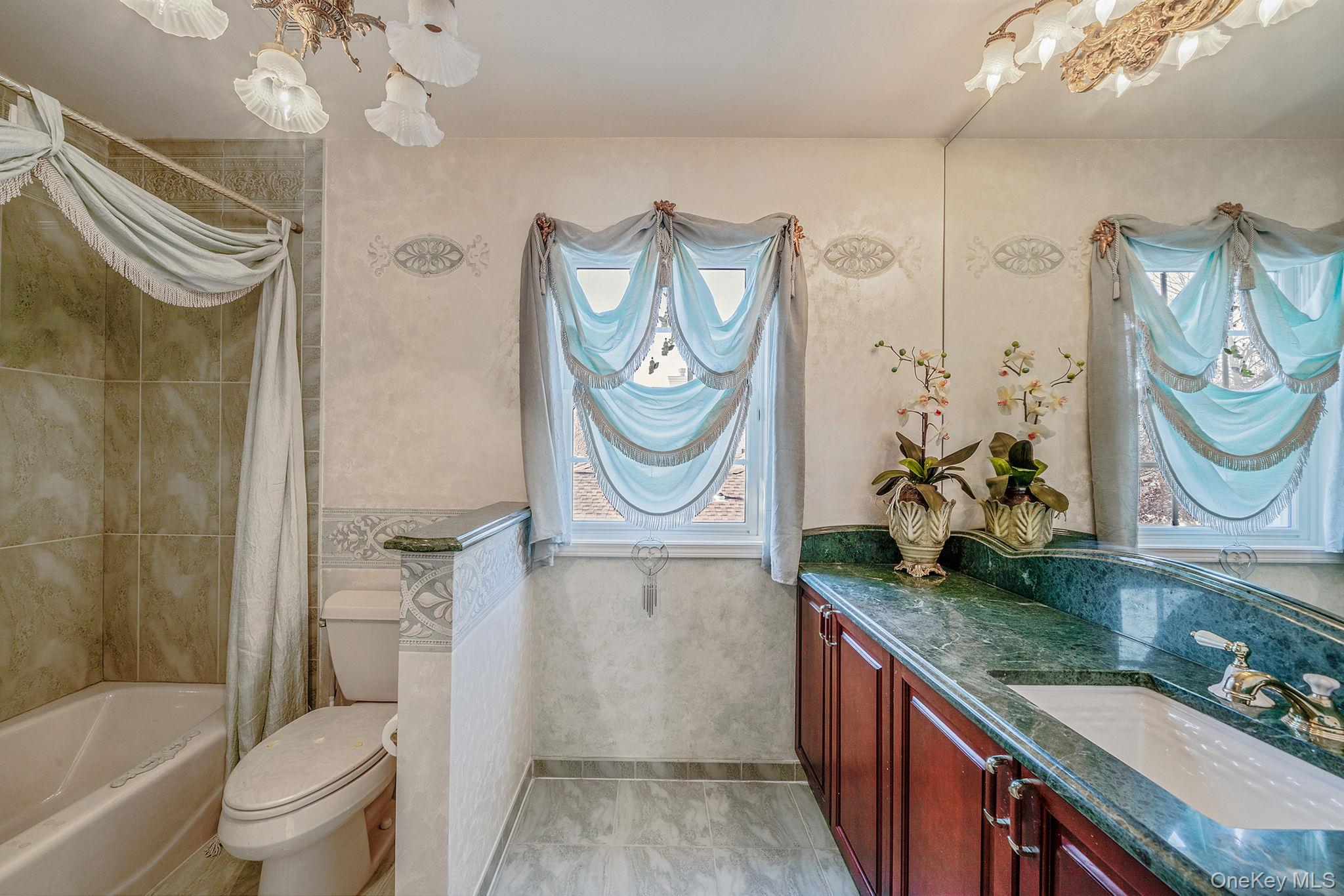 148 Country Club Drive Commack, NY 11725 - Photo 31 of 50 a bathroom with a granite countertop toilet sink and mirror
