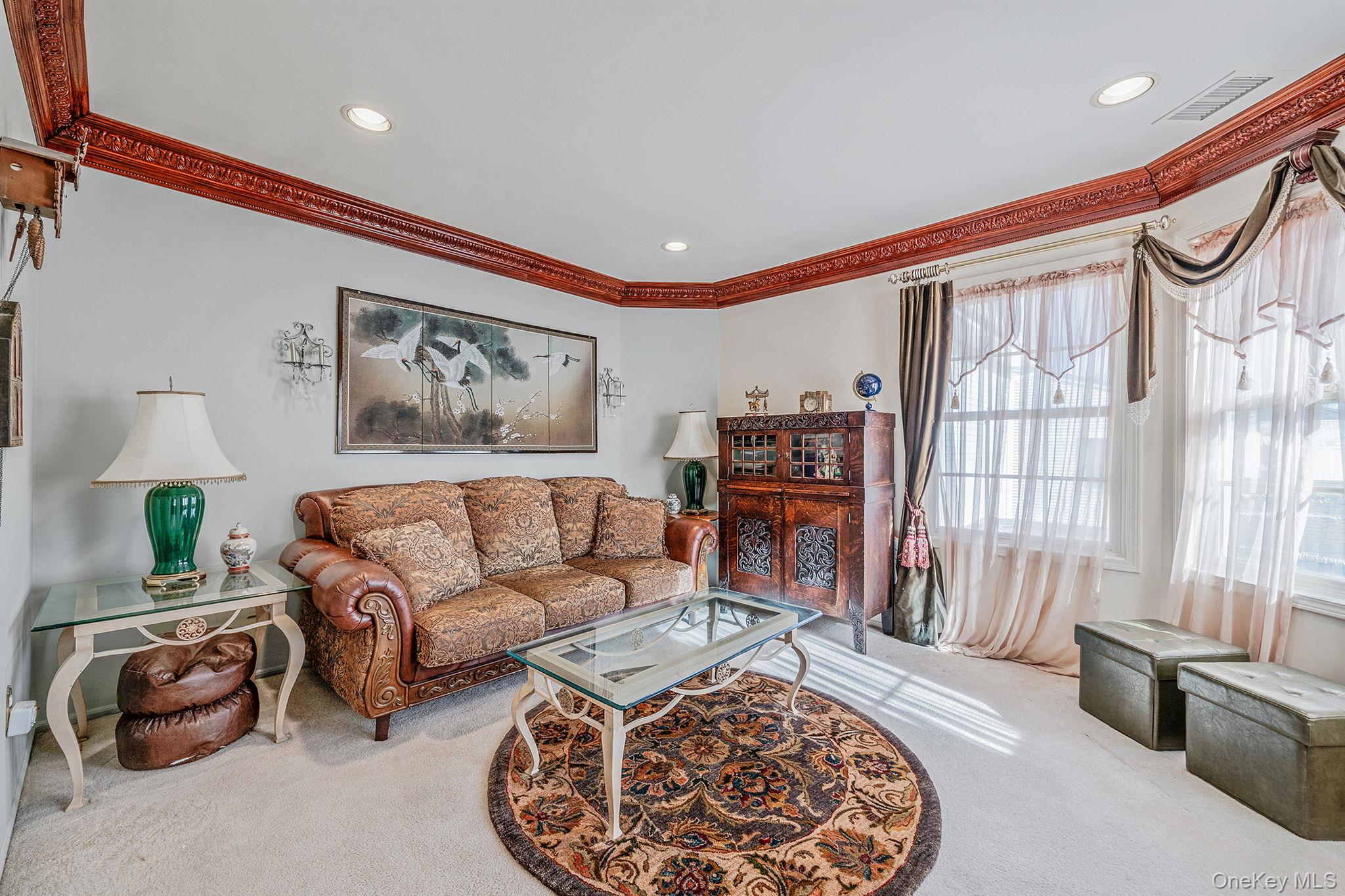148 Country Club Drive Commack, NY 11725 - Photo 32 of 50 a living room with furniture and a flat screen tv
