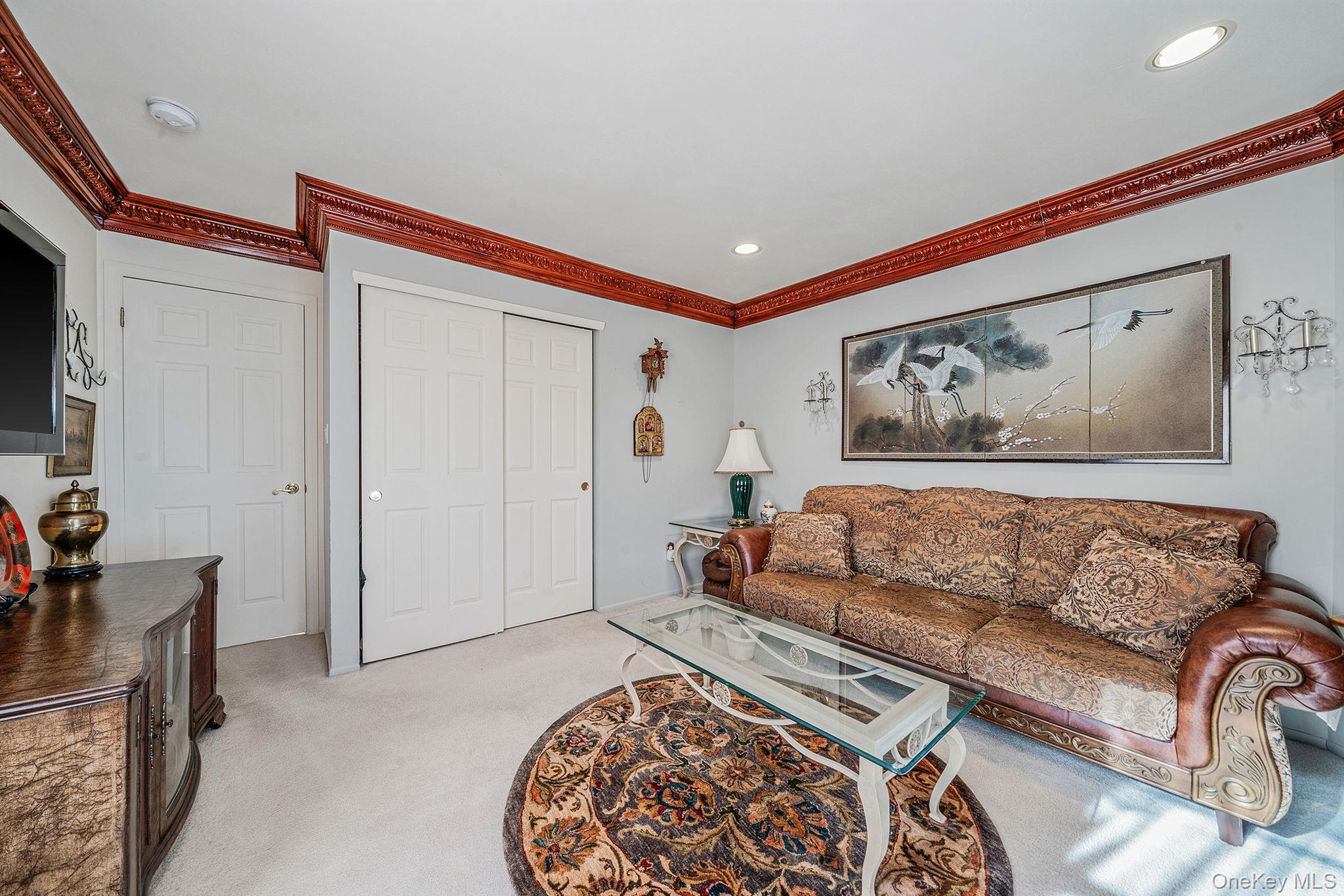 148 Country Club Drive Commack, NY 11725 - Photo 33 of 50 a living room with furniture and a couch
