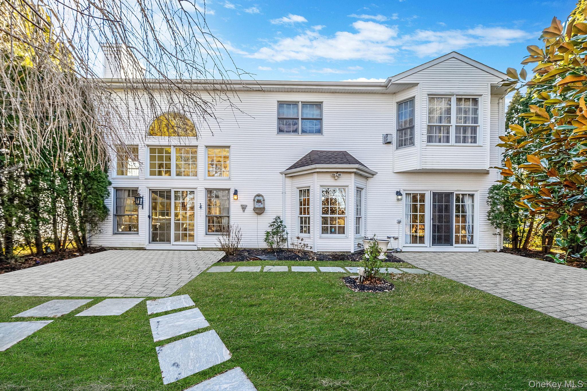 148 Country Club Drive Commack, NY 11725 - Photo 39 of 50 a front view of a house with a yard
