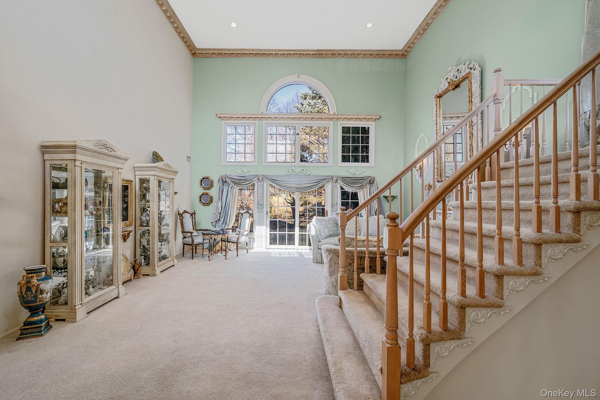 148 Country Club Drive Commack, NY 11725 - Photo 8 of 50 a view of staircase with furniture and a chandelier