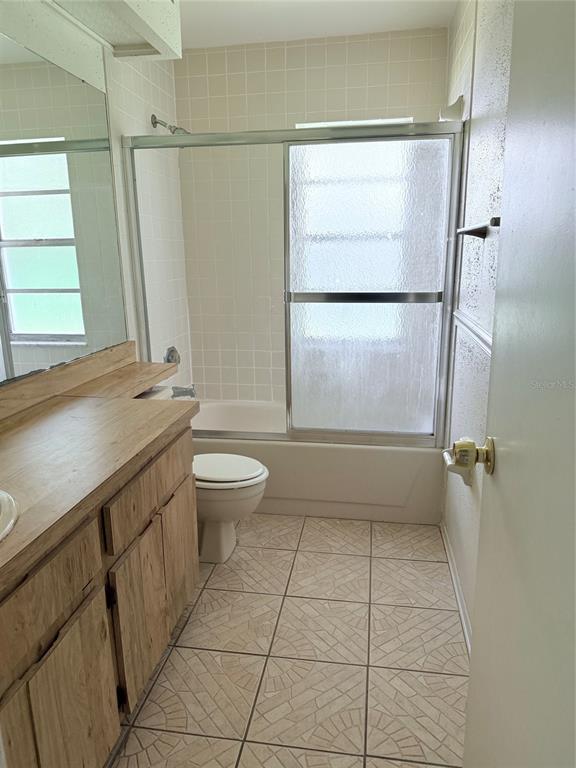 1636 Baker Road Lutz, FL 33559 - Photo 8 of 13 a bathroom with a granite countertop sink toilet and shower