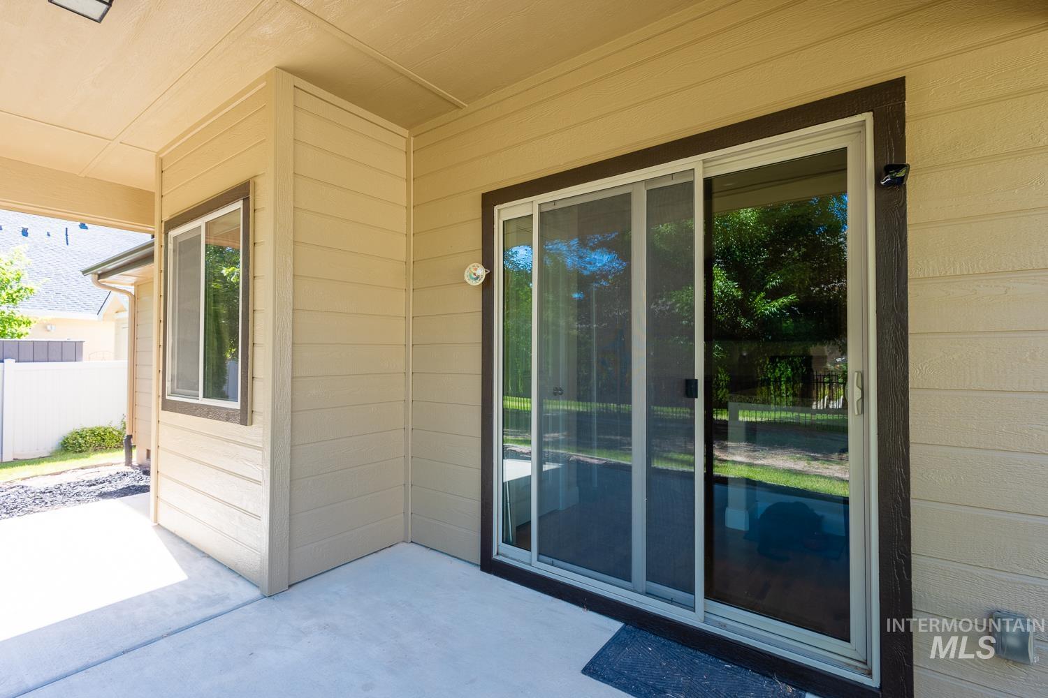 1186 East Observation Street Meridian, ID 83642 - Photo 29 of 33 Covered concrete patio featuring a sliding glass door with a screen, a secondary window, and horizontal siding