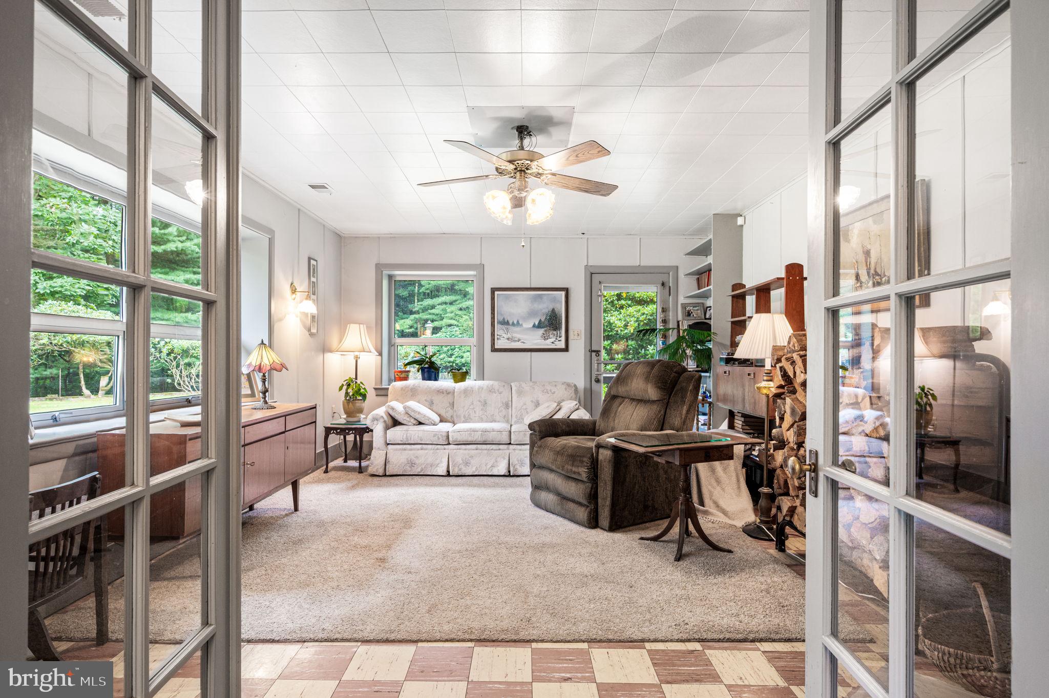 38 Lutz Road Boyertown, PA 19512 - Photo 22 of 49 a living room with furniture a large window and a chandelier