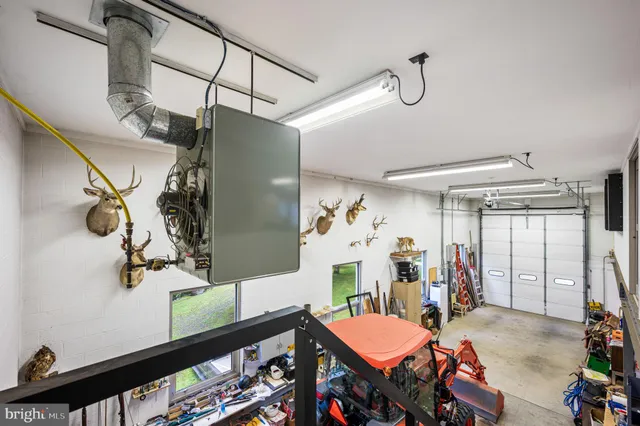 a view of a garage with cars and other equipment