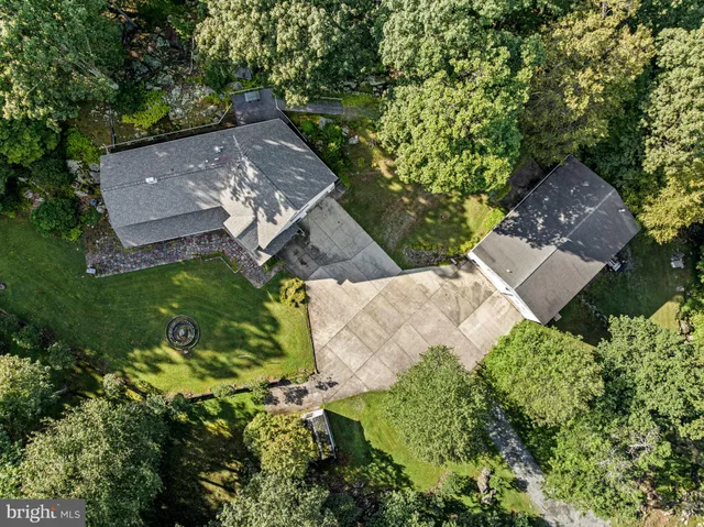an aerial view of a house with a yard
