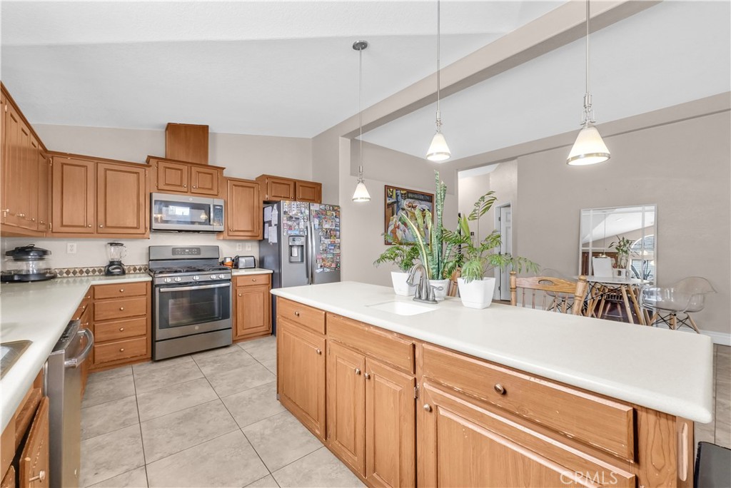 4901 Green River Road, Unit 102 Corona, CA 92878 - Photo 11 of 39 a kitchen with stainless steel appliances granite countertop a sink and cabinets