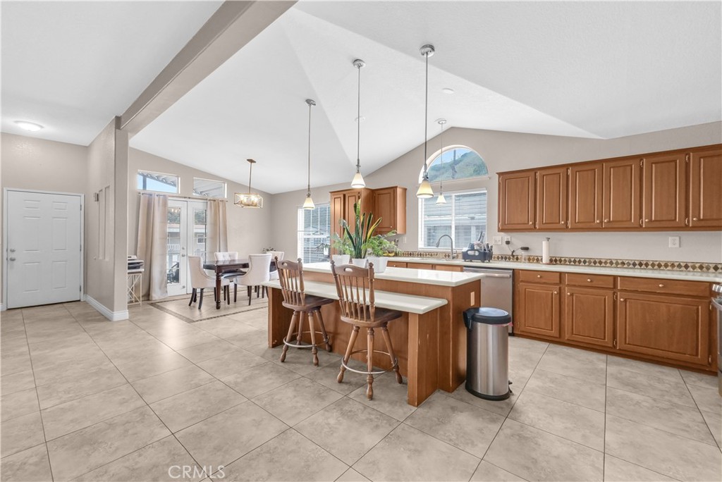 4901 Green River Road, Unit 102 Corona, CA 92878 - Photo 12 of 39 a kitchen with a dining table chairs and white cabinets