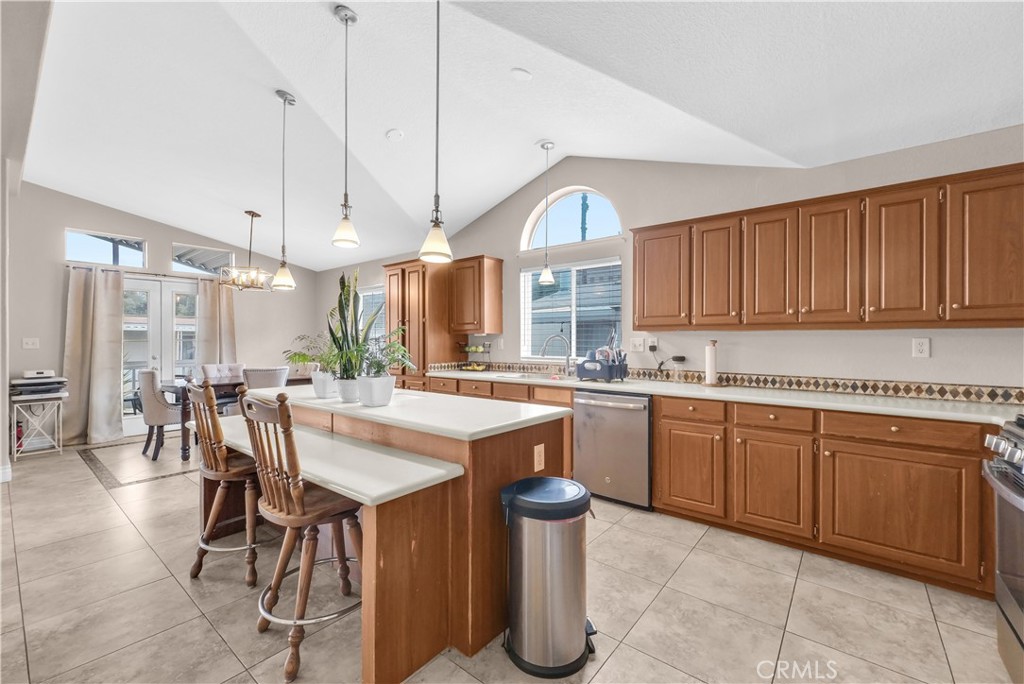 4901 Green River Road, Unit 102 Corona, CA 92878 - Photo 13 of 39 a kitchen with granite countertop a sink cabinets and window