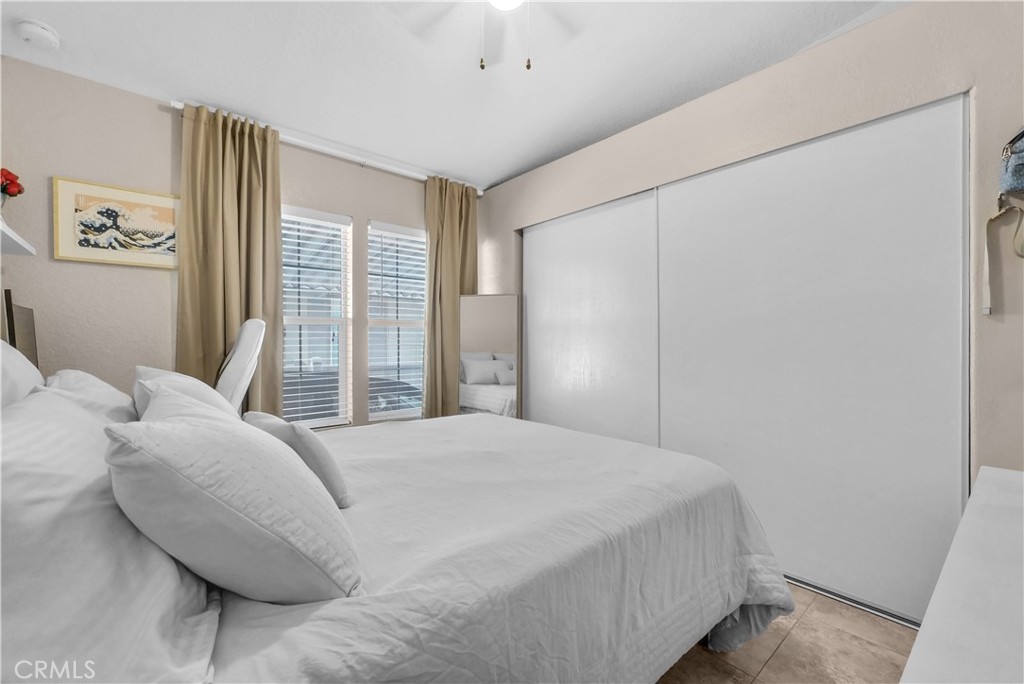 4901 Green River Road, Unit 102 Corona, CA 92878 - Photo 15 of 39 a bedroom with a bed and a large window