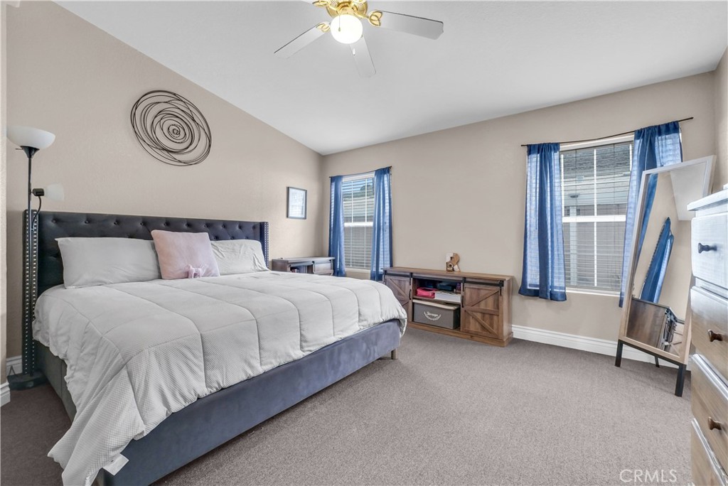 4901 Green River Road, Unit 102 Corona, CA 92878 - Photo 24 of 39 a bedroom with a bed and a chandelier