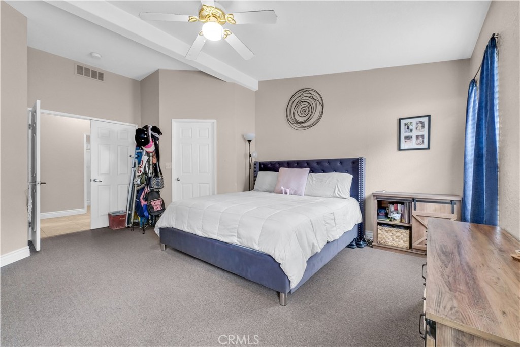 4901 Green River Road, Unit 102 Corona, CA 92878 - Photo 25 of 39 a bedroom with a bed and a chandelier