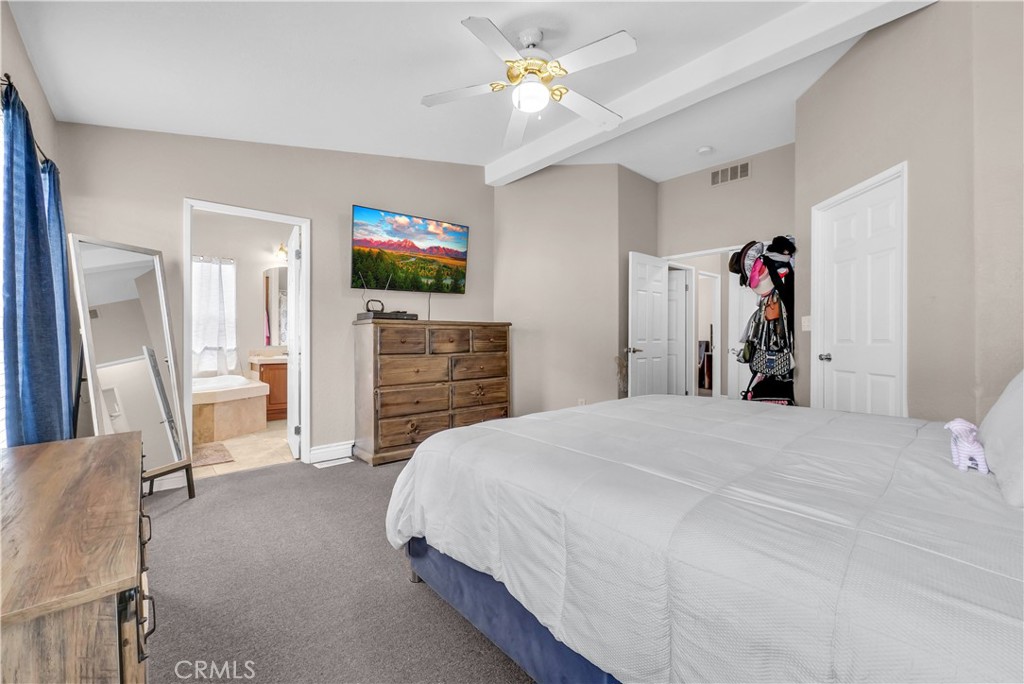 4901 Green River Road, Unit 102 Corona, CA 92878 - Photo 26 of 39 a bedroom with a bed and a television