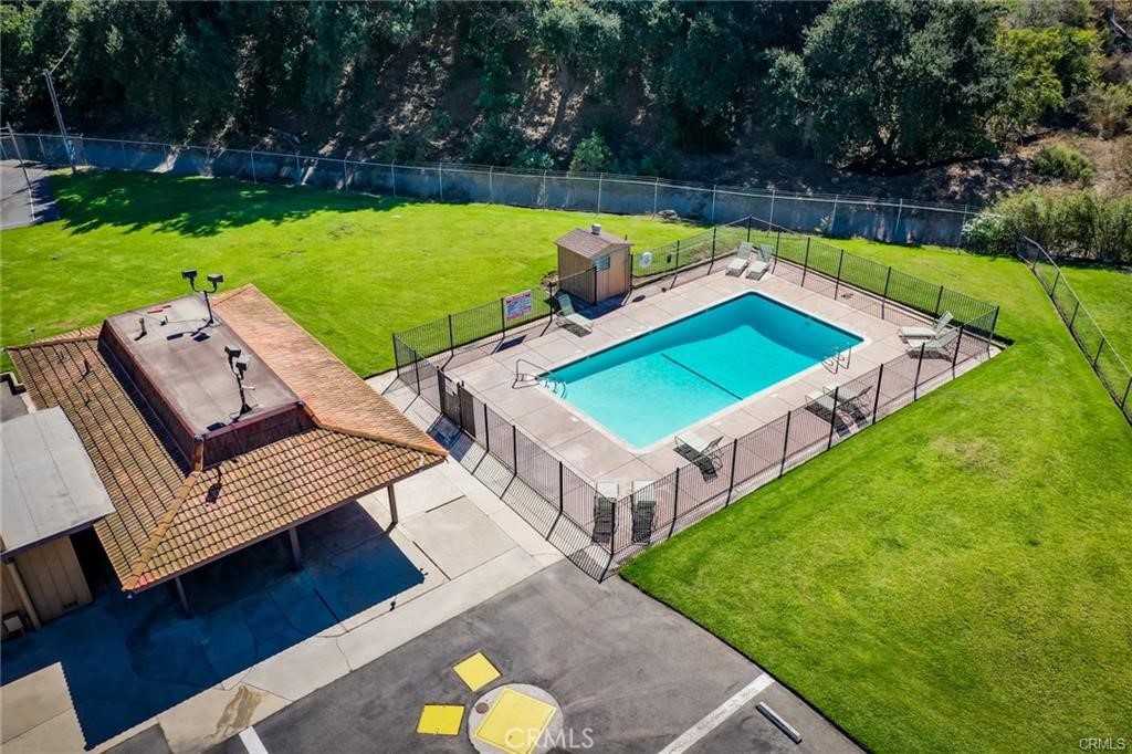 4901 Green River Road, Unit 102 Corona, CA 92878 - Photo 33 of 39 a view of a chairs and table in backyard of the house