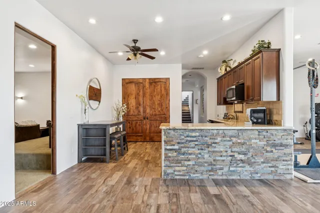 a view of a livingroom with wooden floor and a window