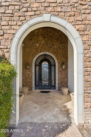 a kitchen with stainless steel appliances a stove top oven a sink a dining table and chairs with wooden floor