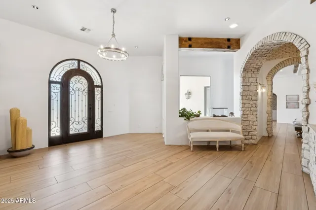 a view of a dining room with furniture and a chandelier