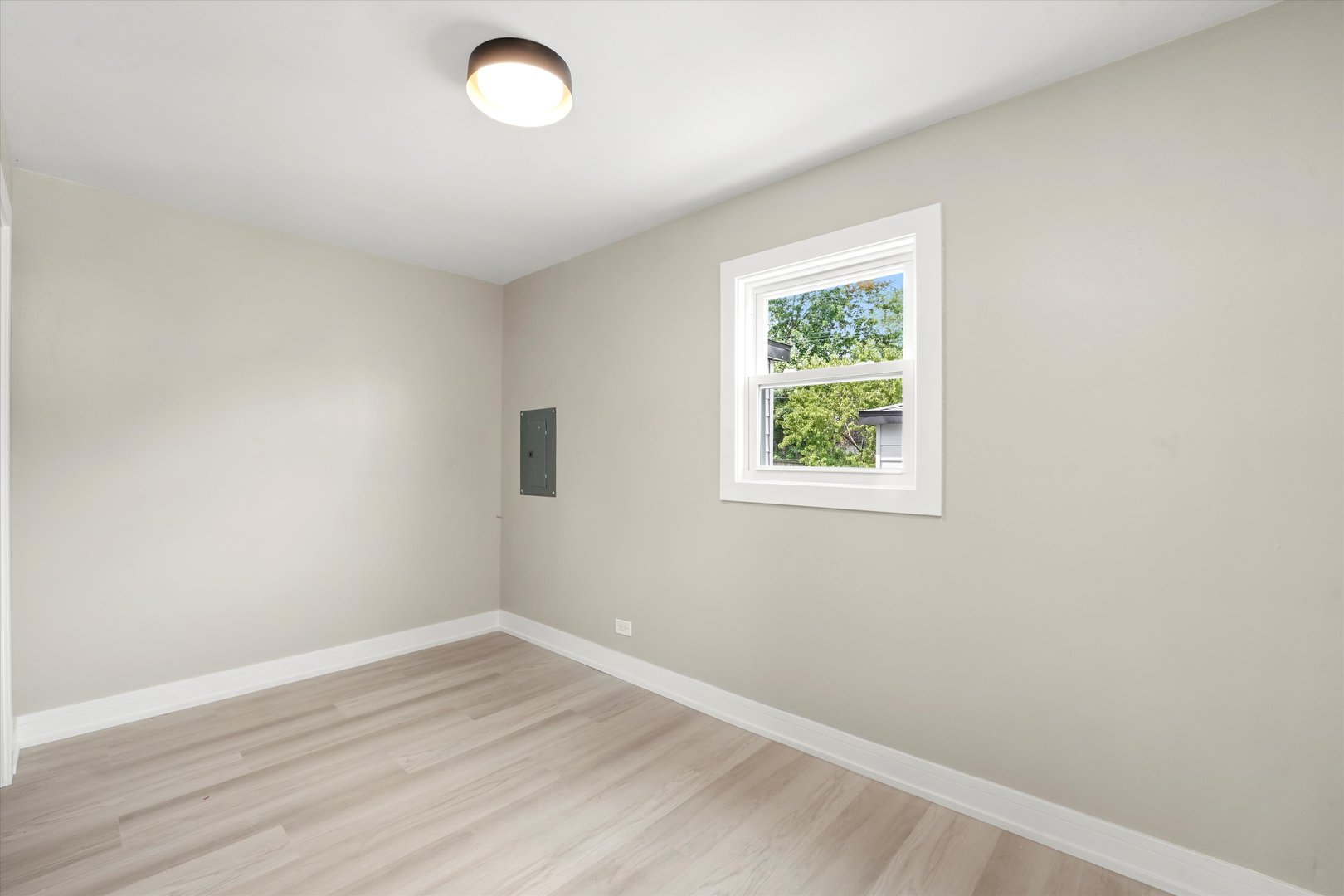 16218 Honore Avenue Markham, IL 60428 - Photo 16 of 25 an empty room with wooden floor and windows