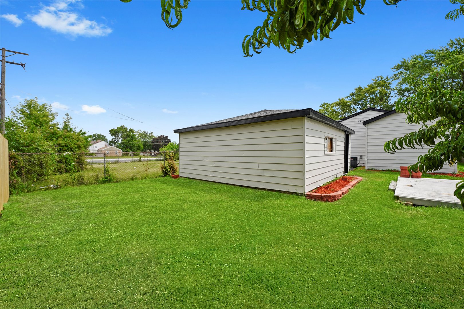 16218 Honore Avenue Markham, IL 60428 - Photo 24 of 25 a view of a backyard with plants and large trees