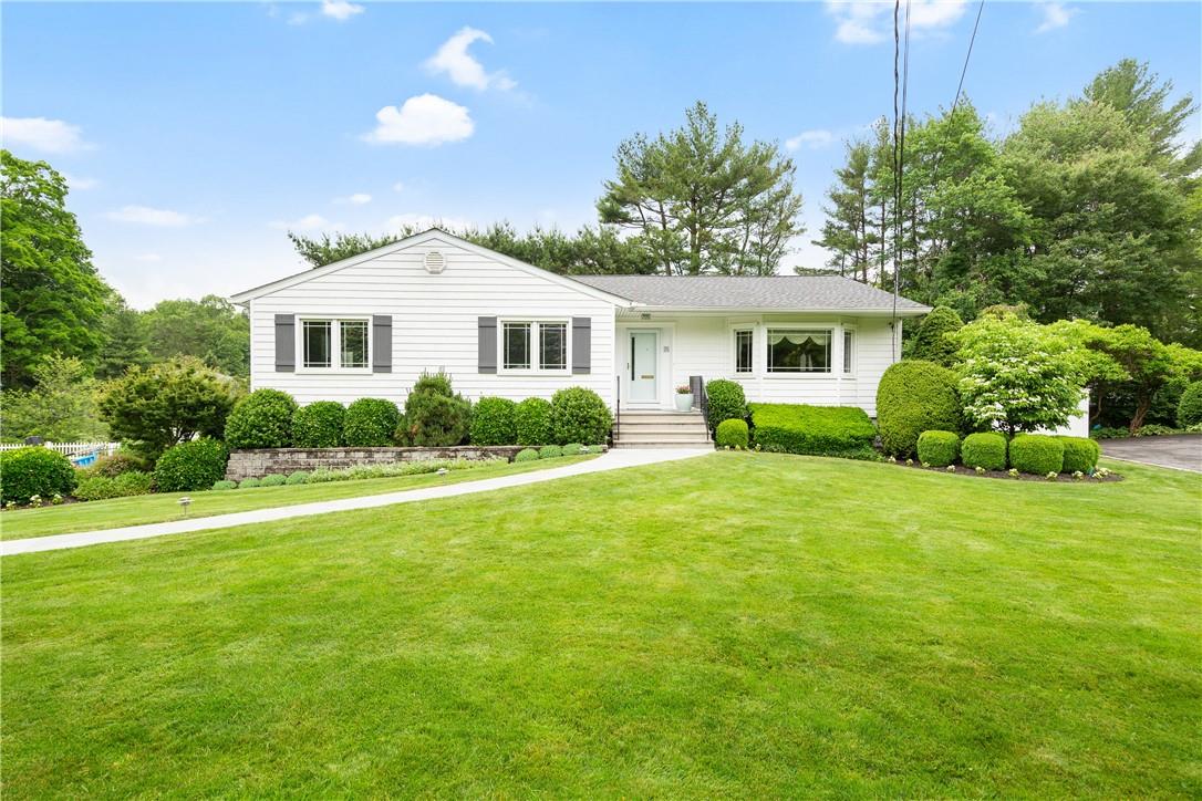 a front view of a house with garden