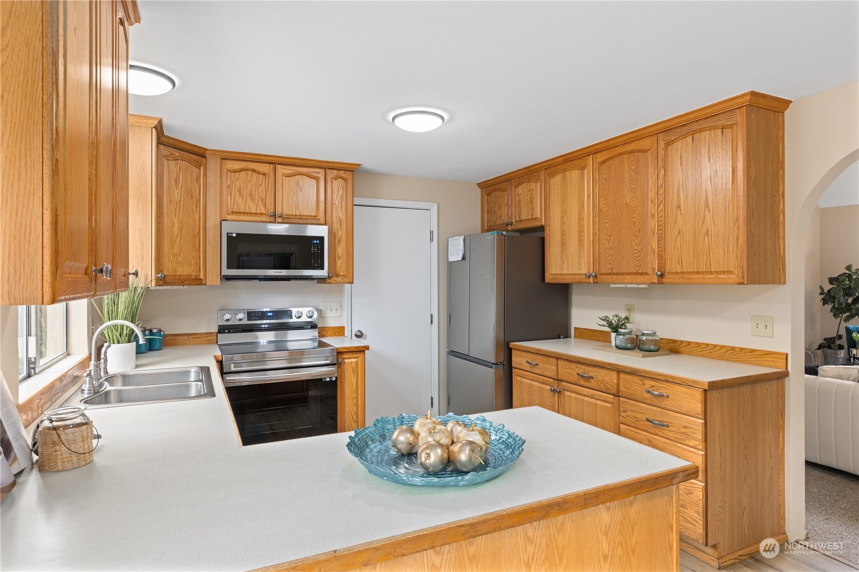 2012 233rd Street Southeast Bothell, WA 98021 - Photo 13 of 39 a kitchen with stainless steel appliances kitchen island granite countertop a sink stove and refrigerator