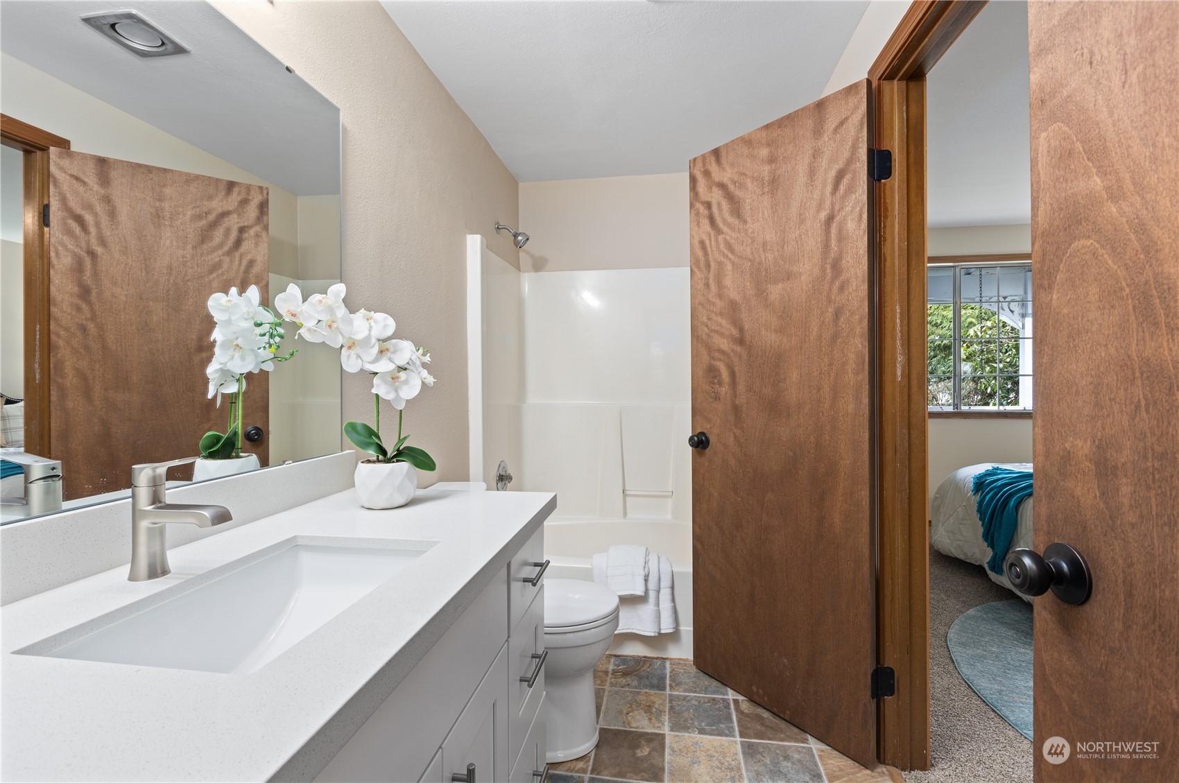 2012 233rd Street Southeast Bothell, WA 98021 - Photo 21 of 39 a bathroom with a granite countertop sink a toilet and shower
