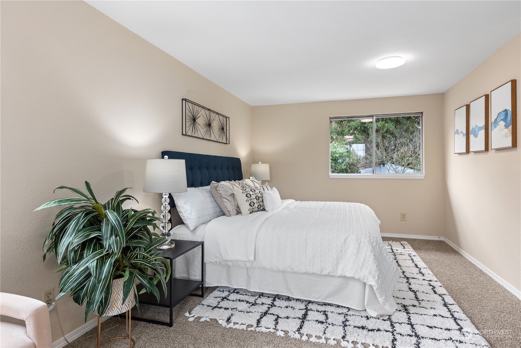 2012 233rd Street Southeast Bothell, WA 98021 - Photo 30 of 39 a bedroom with a large bed and a potted plant