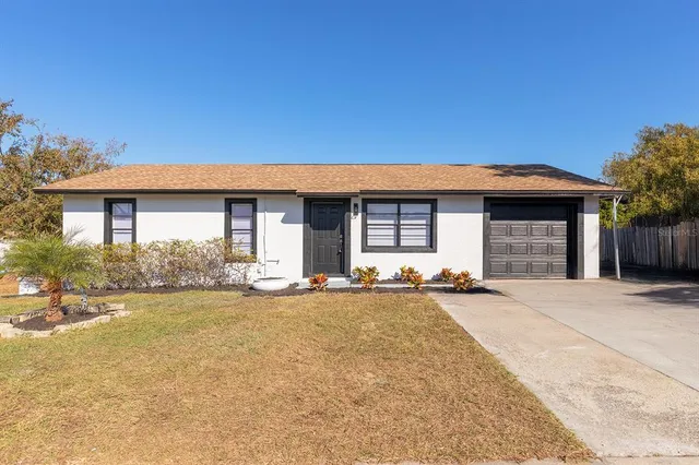 a front view of a house with a garden and yard