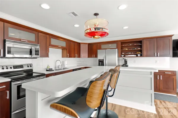 a kitchen with stainless steel appliances granite countertop a sink and stove top oven